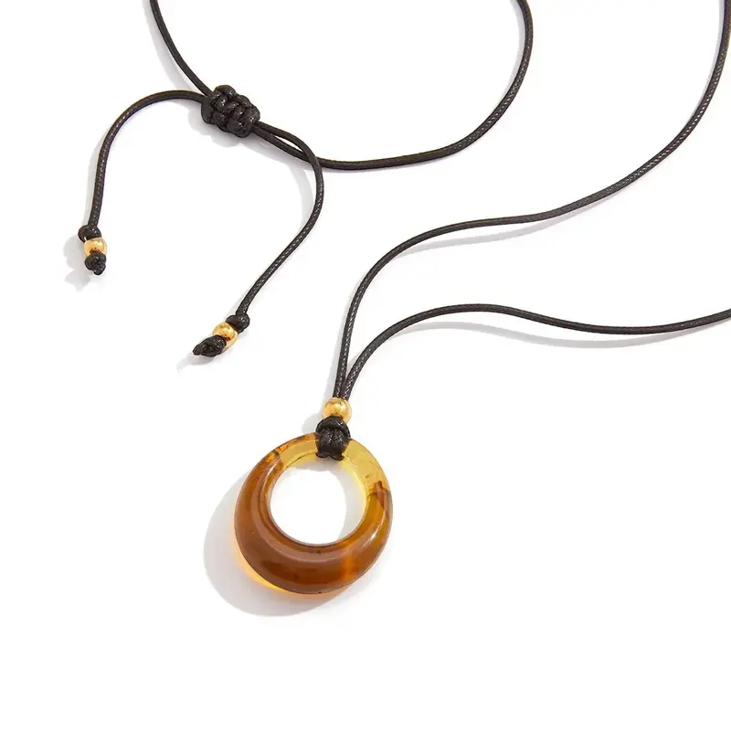Amber-Colored Resin Long Necklace With A Black Cord. 1