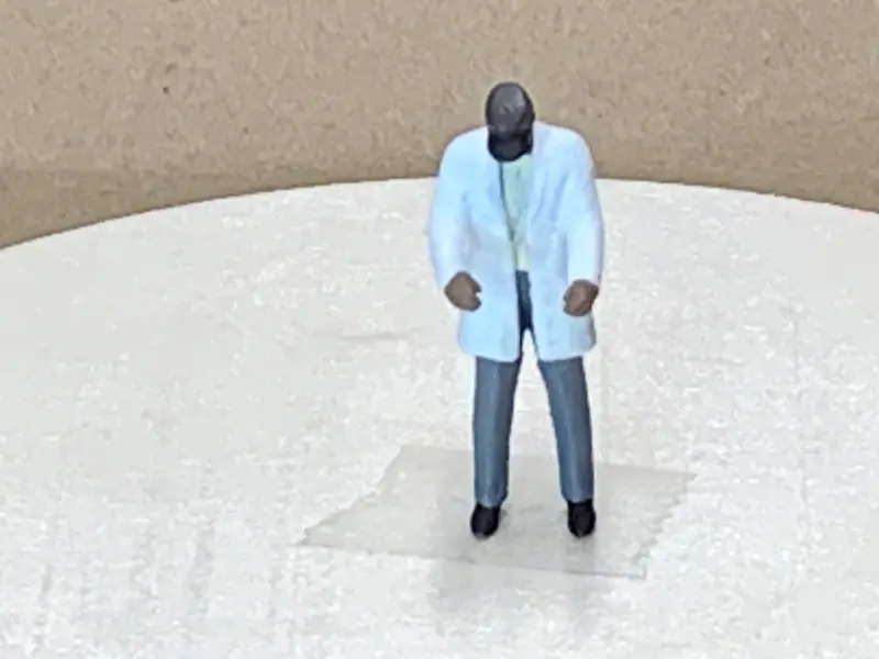Man Standing Long Coat Cap 1