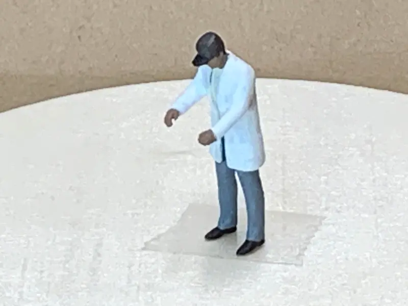 Man Standing Long Coat Cap 2